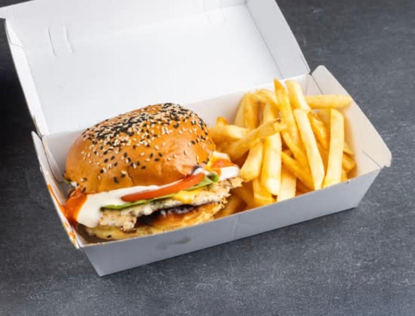 Chicken burger with fries in a takeaway box