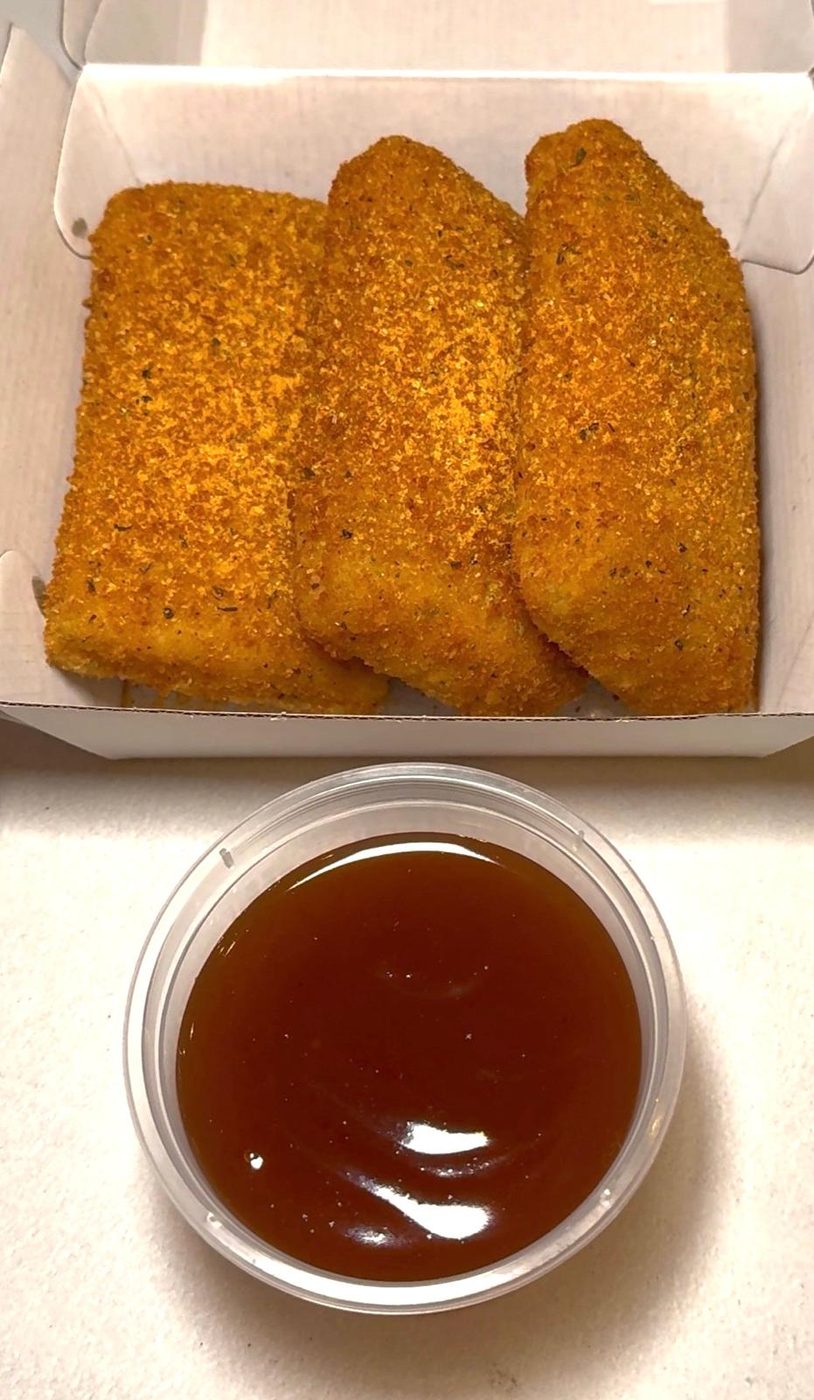 Crispy golden tenders with a side of dipping sauce